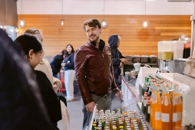 People ordering drinks at a counter with bottles Beverage area at The Douglas - Student Housing Apartments in Seattle Student Accommodation