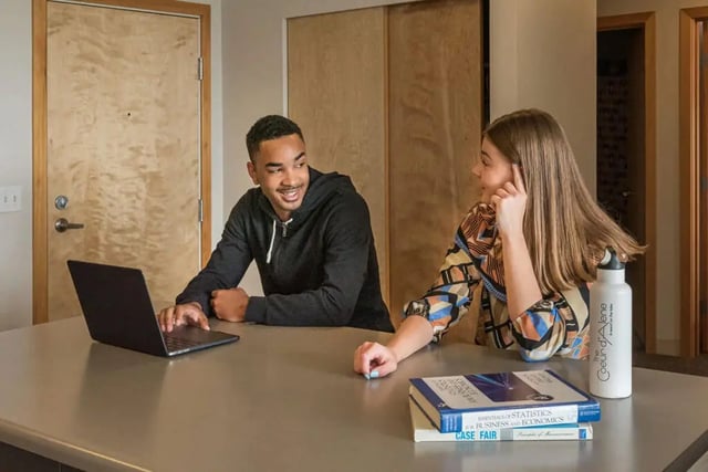 Students with laptop and books at counter study area at The Douglas - Student Housing Apartments in Seattle Student Accommodation