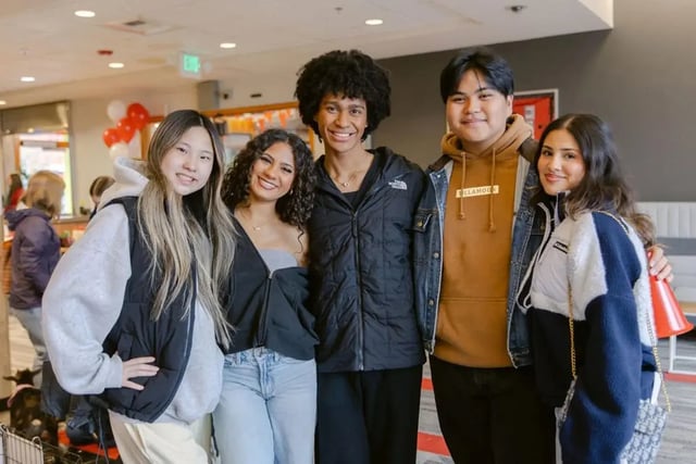 Five students standing together indoors communal area at The Douglas - Student Housing Apartments in Seattle Student Accommodation