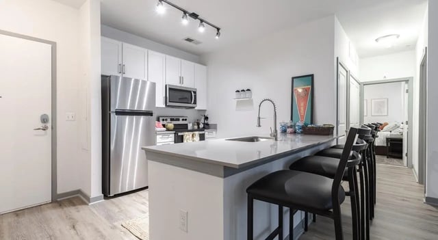 Stainless steel fridge counter stools and kitchen at The Varsity College Park in College Park Student Accommodation