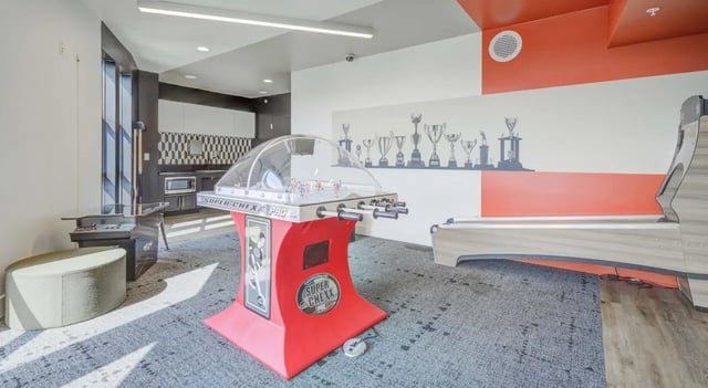 Foosball table and trophy mural recreation area at The Varsity College Park in College Park Student Accommodation