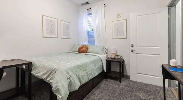 Bed with side table and desk bedroom at The Varsity College Park in College Park Student Accommodation