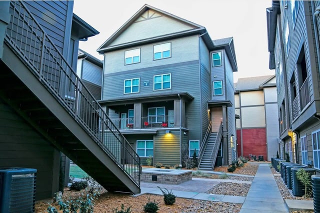 Apartment building exterior with stairs and fire pit at The Bloc in Lubbock Student Accommodation