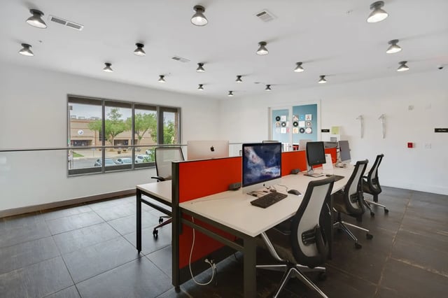 Computers and chairs in a modern study area at The Bloc in Lubbock Student Accommodation