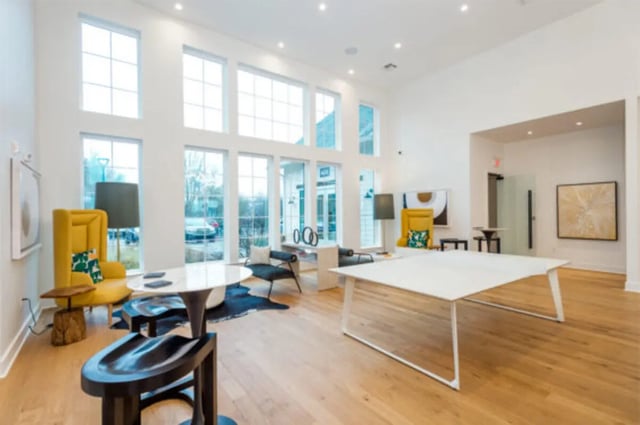 Yellow chair white tables black stools living room at The Husk and The Helm in Cullowhee Student Accommodation