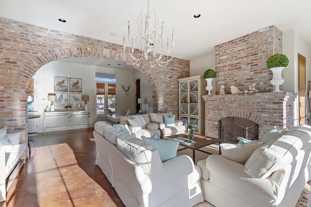 White sofas brick fireplace and arch living room at The Cottages at Hooper Hollow in Oxford Student Accommodation