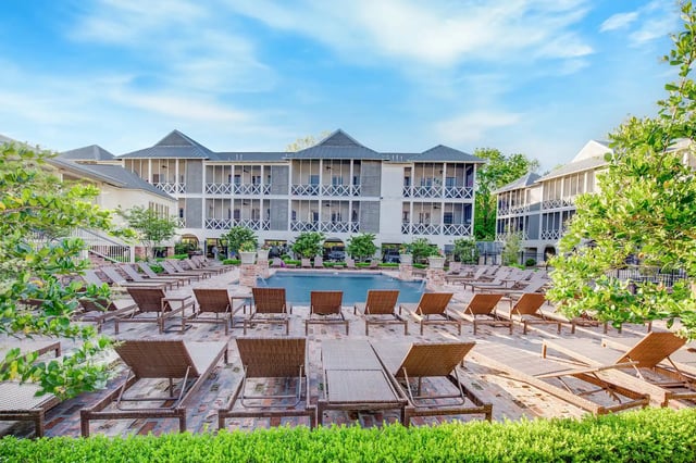 Lounge chairs surround a pool exterior at The Cottages at Hooper Hollow in Oxford Student Accommodation