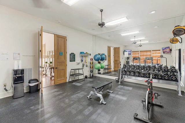 Dumbbells exercise bike weight bench fitness center at The Cottages at Hooper Hollow in Oxford Student Accommodation