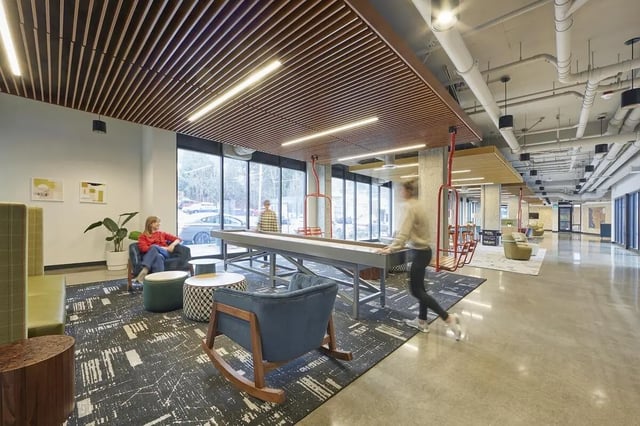 Shuffleboard table lounge chairs and game area communal area at Stateside in Bellingham Student Accommodation