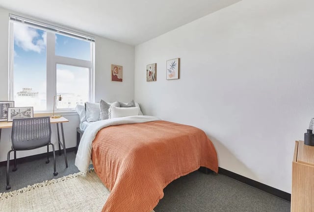 Bed desk chair artwork and window bedroom at Stateside in Bellingham Student Accommodation