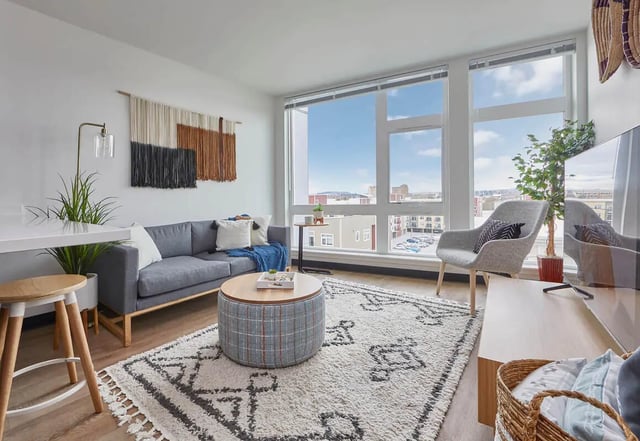 Sofa coffee table rug chair TV living room at Stateside in Bellingham Student Accommodation