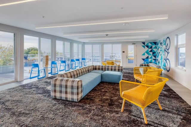 Sofa blue chairs yellow chairs living room at Stateside in Bellingham Student Accommodation