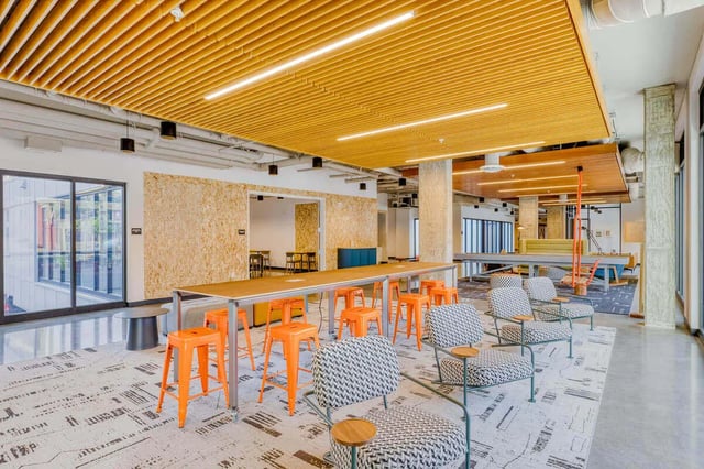 Orange stools long table patterned chairs communal area at Stateside in Bellingham Student Accommodation