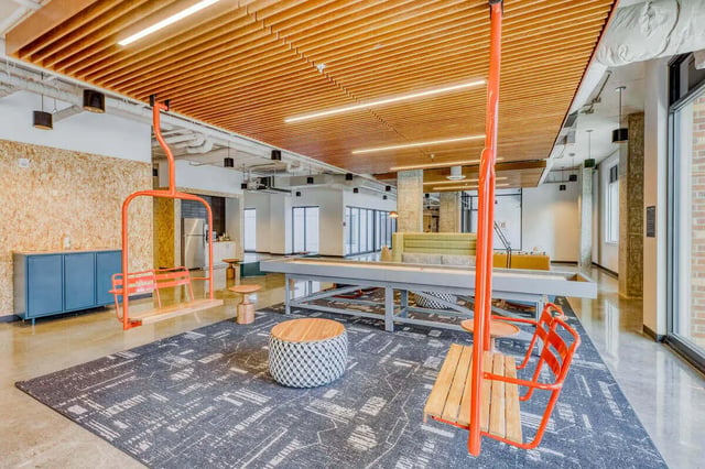 Orange ski lift seats with patterned rug living area at Stateside in Bellingham Student Accommodation