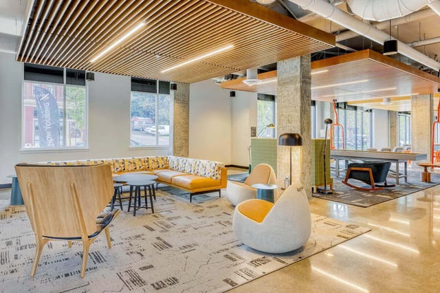 Modern lounge with sectional sofa and chairs living area at Stateside in Bellingham Student Accommodation