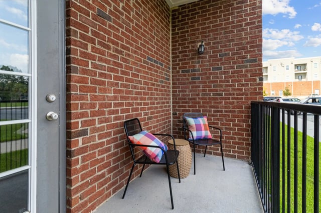 Two chairs and table on balcony exterior at Remerton Mill Apartments in Valdosta Student Accommodation