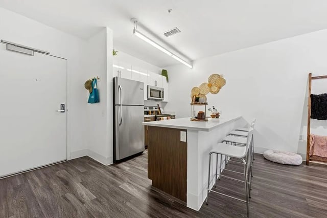 Refrigerator island with stools kitchen counter area kitchen at Slate at 901 in Knoxville Student Accommodation