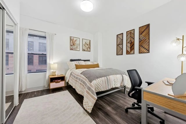 Bed desk chair and rug bedroom at Slate at 901 in Knoxville Student Accommodation