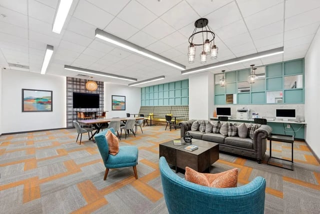 Modern lounge with sofas tables computers living room at Slate at 901 in Knoxville Student Accommodation