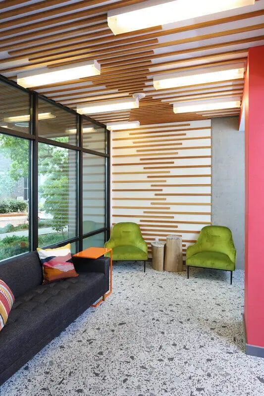 Sofa chairs and wood accent wall lounge area at NORA Apartments in Seattle Student Accommodation