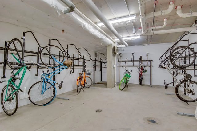 Bikes on racks concrete floor storage area at NORA Apartments in Seattle Student Accommodation