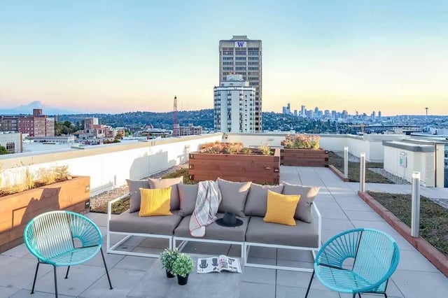 Sofa planter chairs and coffee table outdoor area at NOLAN Apartments in Seattle Student Accommodation