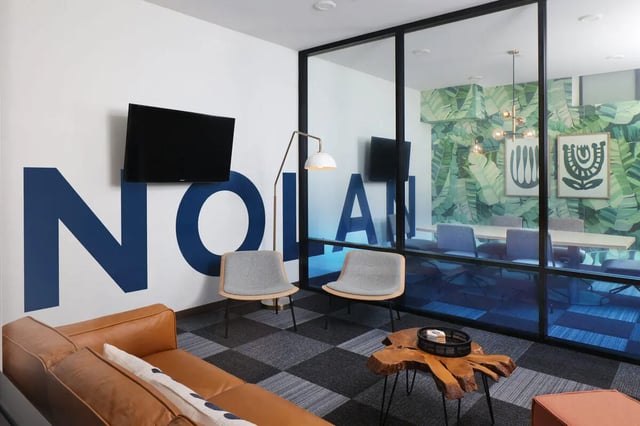 Sofa chairs television large letters and meeting room Living room at NOLAN Apartments in Seattle Student Accommodation
