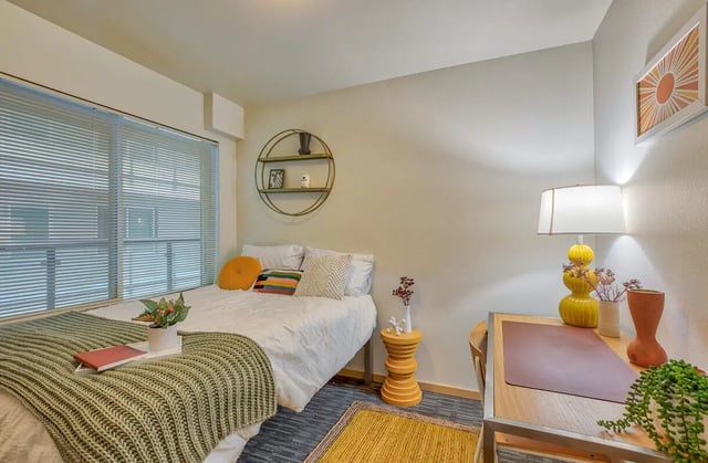 Bed desk lamp and wall art bedroom at NOLAN Apartments in Seattle Student Accommodation