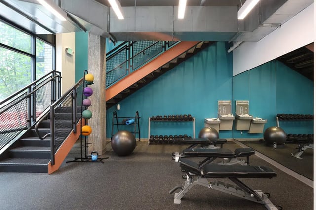 Dumbbells benches stability balls gym fitness area at NOLAN Apartments in Seattle Student Accommodation