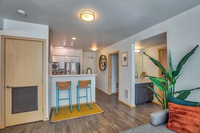 Bar stools and kitchen counter living room kitchen at NOLAN Apartments in Seattle Student Accommodation