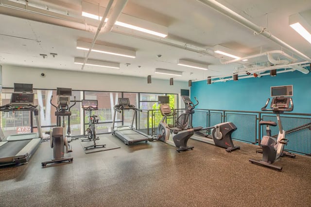 Treadmills ellipticals stationary bikes gym equipment Fitness Area at NOLAN Apartments in Seattle Student Accommodation