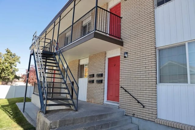 Exterior stairs with red doors and mailboxes exterior at Haven White Apartments in Rexburg Student Accommodation