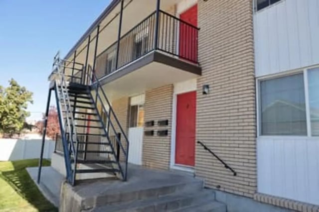 Exterior stairs lead to red doors on building exterior at Haven Red Apartments in Rexburg Student Accommodation