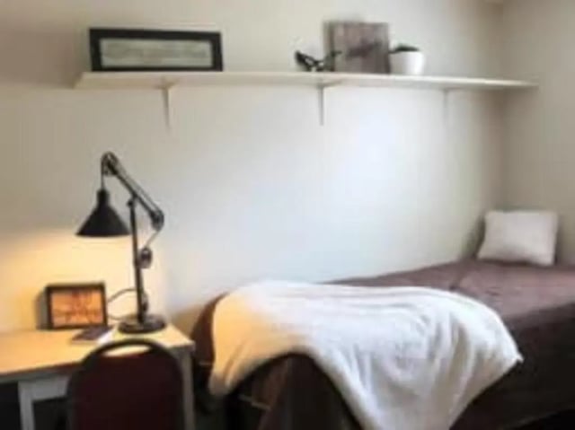 Desk lamp bed picture shelf bedroom at Haven Red Apartments in Rexburg Student Accommodation