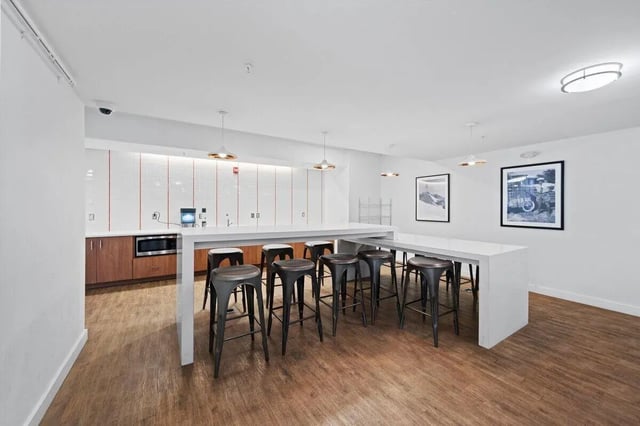 Bar stools at counter with microwave kitchen area at Landmark Apartments in College Park Student Accommodation