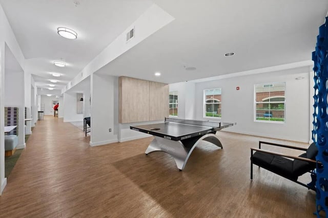 Ping pong table and lounge chair common area at Landmark Apartments in College Park Student Accommodation