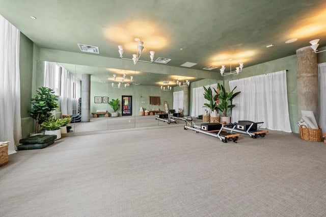 Pilates reformers plants large mirror fitness studio at Landmark Apartments in College Park Student Accommodation