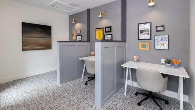 Two desks with chairs artwork and globes study area at Maison Burbank in Baton Rouge Student Accommodation