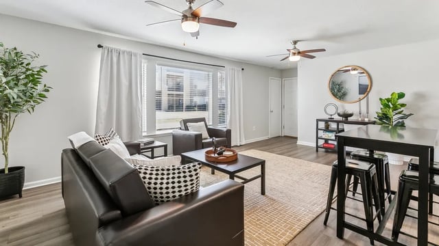 Leather sofas coffee table and bar stools living room at Maison Burbank in Baton Rouge Student Accommodation