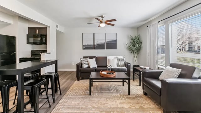 Leather couch coffee table stools kitchen living room at Maison Burbank in Baton Rouge Student Accommodation
