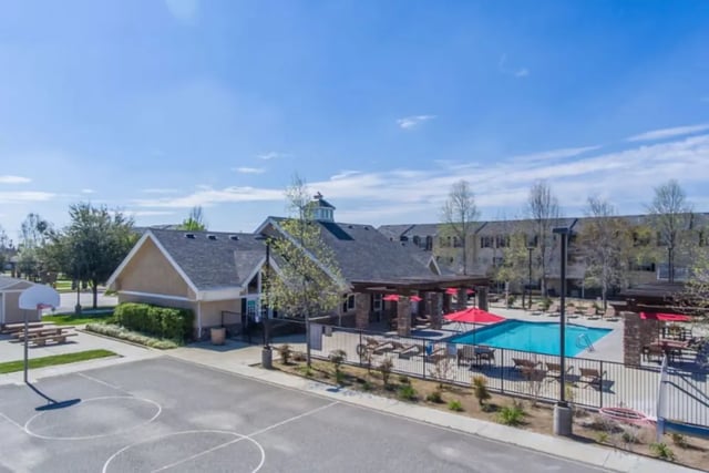 Basketball court pool and picnic tables exterior at Copper Beech Townhomes in Clovis Student Accommodation