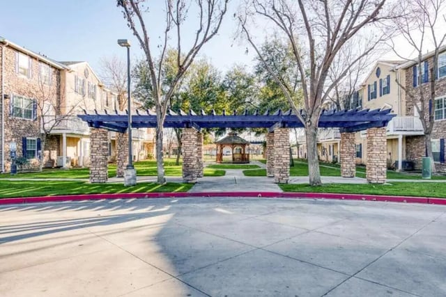 Apartment buildings blue pergola gazebo exterior at Copper Beech Townhomes in Clovis Student Accommodation
