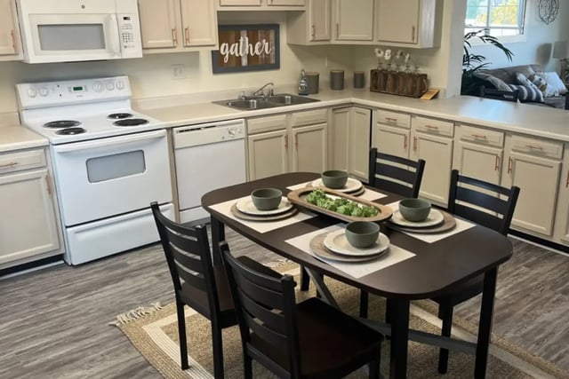 Kitchen with table chairs stove and cabinets kitchen at Copper Beech Townhomes in Clovis Student Accommodation