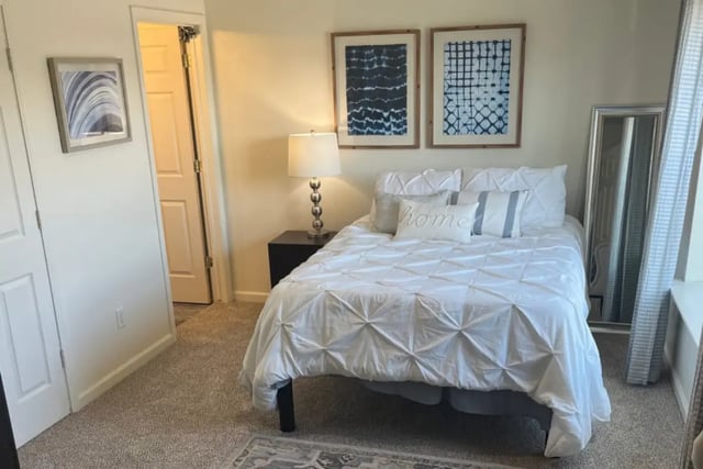 Bed with white duvet and decor bedroom at Copper Beech Townhomes in Clovis Student Accommodation