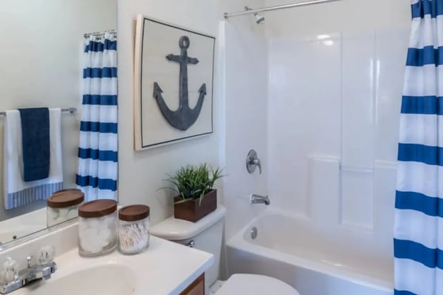 Anchor decor blue striped shower curtain and bathtub Bathroom at Copper Beech Townhomes in Clovis Student Accommodation