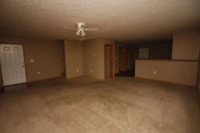 Door ceiling fan and open doors living room at Conner Crossing Apartments -"The Porches" in West Lafayette Student Accommodation