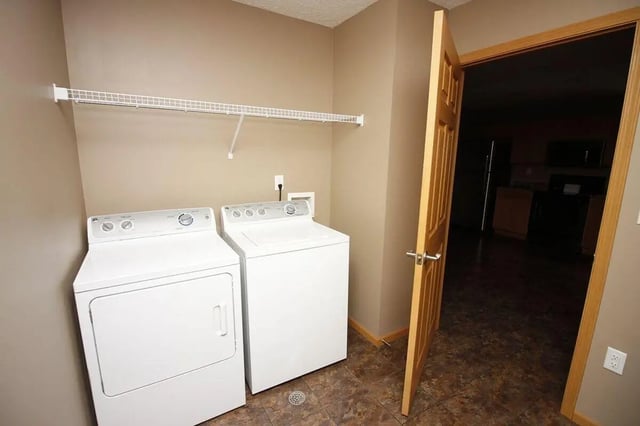 Washer dryer white shelf open door Laundry Room at Conner Crossing Apartments -"The Porches" in West Lafayette Student Accommodation