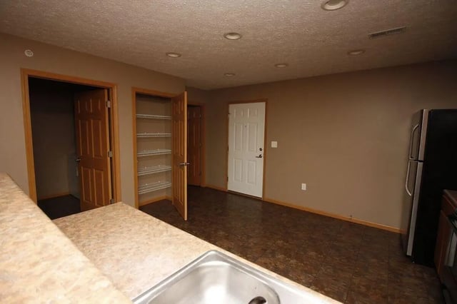 Counter sink doors shelves refrigerator kitchen at Conner Crossing Apartments -"The Porches" in West Lafayette Student Accommodation