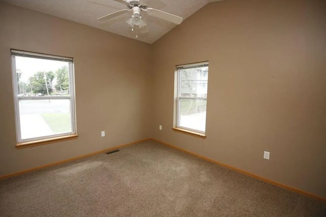 Tan room ceiling fan two windows bedroom at Conner Crossing Apartments -"The Porches" in West Lafayette Student Accommodation