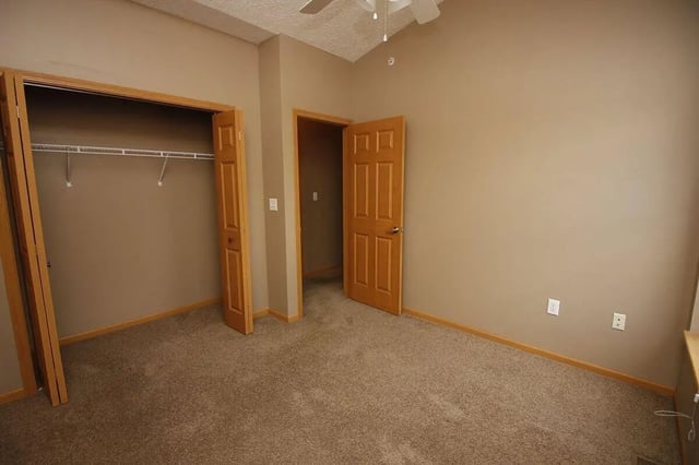 Open closet and doors in beige bedroom interior at Conner Crossing Apartments -"The Porches" in West Lafayette Student Accommodation